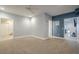 Large bedroom with neutral carpeting and multiple doorways, providing versatile space and easy access to other areas at 210 Little River Farms Trl, Canton, GA 30115