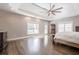 Sunlit bedroom with hardwood floors, decorative ceiling, and neutral walls at 210 Little River Farms Trl, Canton, GA 30115