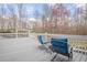 Outdoor deck with lounge chairs overlooking the landscaped backyard at 210 Little River Farms Trl, Canton, GA 30115