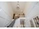 Bright foyer featuring wainscoting, grand staircase, chandelier, and soaring ceilings at 210 Little River Farms Trl, Canton, GA 30115