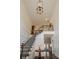 Grand foyer with high ceilings, a staircase with iron railings, and elegant wood trim at 210 Little River Farms Trl, Canton, GA 30115