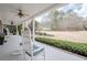 Inviting front porch with rocking chairs overlooking a spacious lawn and mature trees at 210 Little River Farms Trl, Canton, GA 30115