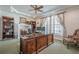Spacious office featuring large desk, built-in bookshelves, tray ceiling, and ample natural light at 210 Little River Farms Trl, Canton, GA 30115