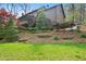 Inviting backyard with terraced landscaping, a screened porch, and stairs leading to an upper level deck at 2702 Long Lake Ne Ter, Roswell, GA 30075