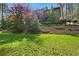 Beautiful backyard with a well-maintained lawn, terraced landscaping, and steps leading to an upper deck at 2702 Long Lake Ne Ter, Roswell, GA 30075