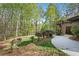 Secluded backyard with mature trees and landscaping, featuring a private driveway at 2702 Long Lake Ne Ter, Roswell, GA 30075