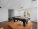 Finished basement featuring a pool table, recessed lights and access to the exterior through French doors at 2702 Long Lake Ne Ter, Roswell, GA 30075