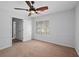 A cozy bedroom featuring a ceiling fan and a window that lets in plenty of natural light at 2702 Long Lake Ne Ter, Roswell, GA 30075