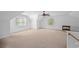 A spacious bonus room is illuminated by natural light from large windows and features carpet floors at 2702 Long Lake Ne Ter, Roswell, GA 30075