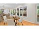 Cozy breakfast nook with a round table and chairs adjacent to a kitchen with hardwood floors and natural light at 2702 Long Lake Ne Ter, Roswell, GA 30075