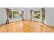 Spacious, sunlit room with hardwood floors and large windows offering outdoor views, perfect for versatile use at 2702 Long Lake Ne Ter, Roswell, GA 30075