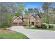 Charming brick home boasts a two-car garage, lush landscaping, and a welcoming driveway at 2702 Long Lake Ne Ter, Roswell, GA 30075