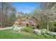 Beautiful brick home with lush landscaping, mature trees, and a well-manicured front lawn at 2702 Long Lake Ne Ter, Roswell, GA 30075