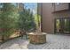 Cozy backyard fire pit with stone surround and a bench, perfect for outdoor relaxation and gatherings at 2702 Long Lake Ne Ter, Roswell, GA 30075