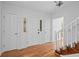 Light-filled foyer with hardwood floors, classic white doors, and a view of the staircase at 2702 Long Lake Ne Ter, Roswell, GA 30075
