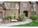 Beautiful brick home showcasing manicured landscaping, a stone bench, and a welcoming front entrance at 2702 Long Lake Ne Ter, Roswell, GA 30075