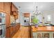 Spacious kitchen featuring wooden floors, cabinets, stainless steel appliances, and a granite countertop island at 2702 Long Lake Ne Ter, Roswell, GA 30075