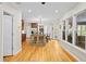Open kitchen with a central island, hardwood floors, and an abundance of natural light from the adjacent windows at 2702 Long Lake Ne Ter, Roswell, GA 30075