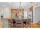 Lovely kitchen with dark countertops, stainless steel appliances, and a chandelier over the island at 2702 Long Lake Ne Ter, Roswell, GA 30075