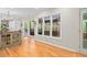 Cozy breakfast nook with an oval table and chairs adjacent to a kitchen with hardwood floors and natural light at 2702 Long Lake Ne Ter, Roswell, GA 30075