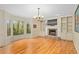 A cozy living room with a fireplace, built-in shelves, and a bay window overlooking nature at 2702 Long Lake Ne Ter, Roswell, GA 30075
