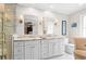 Elegant bathroom with double sink vanity, sconces, walk-in shower, and a window with great natural light at 2702 Long Lake Ne Ter, Roswell, GA 30075