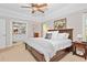 Airy primary bedroom with a queen bed, ensuite bathroom, and neutral tones creates a calming, inviting space at 2702 Long Lake Ne Ter, Roswell, GA 30075