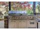 Close up of a premium stainless steel outdoor grill with stone accents, ideal for outdoor cooking at 2702 Long Lake Ne Ter, Roswell, GA 30075