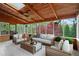 Screened porch featuring wood ceiling and beams and comfortable seating area with nature views at 2702 Long Lake Ne Ter, Roswell, GA 30075