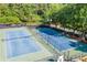 Community tennis courts with blue surface and green trim surrounded by trees at 2702 Long Lake Ne Ter, Roswell, GA 30075