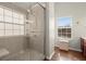 Glass shower in bathroom featuring tile surround, shower head, and bench at 5040 Mundy Ct, Cumming, GA 30028
