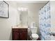 Bathroom featuring a vanity, toilet, shower curtain, and religious art at 5040 Mundy Ct, Cumming, GA 30028