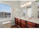 Bright bathroom featuring a double sink vanity, large mirror, and a window with natural light at 5040 Mundy Ct, Cumming, GA 30028