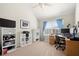Bright bedroom with vaulted ceiling, bookshelves, desk, and a window with blue curtains at 5040 Mundy Ct, Cumming, GA 30028