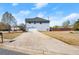 Long driveway leading to a home with an attached garage and a fenced backyard at 5040 Mundy Ct, Cumming, GA 30028