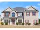 Charming two-story home with a well-manicured front yard and classic architectural details at 5040 Mundy Ct, Cumming, GA 30028