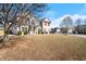 Inviting two-story home with a manicured front lawn and mature trees enhancing its charm at 5040 Mundy Ct, Cumming, GA 30028