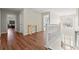 Upstairs landing area with wood floors, a table, a large window, and access to the bedrooms at 5040 Mundy Ct, Cumming, GA 30028