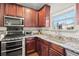 Kitchen showcasing granite counters, modern appliances, and plenty of storage at 5040 Mundy Ct, Cumming, GA 30028