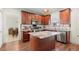 Well-equipped kitchen with a functional island, granite countertops, and rich wood cabinetry at 5040 Mundy Ct, Cumming, GA 30028