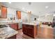 Open concept kitchen featuring a center island, granite countertops, and stainless steel appliances at 5040 Mundy Ct, Cumming, GA 30028