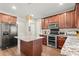 Kitchen showcasing an island, stainless steel appliances, and ample cabinet space at 5040 Mundy Ct, Cumming, GA 30028