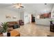 Open living room featuring tile flooring and seamless flow into the kitchen and dining areas at 5040 Mundy Ct, Cumming, GA 30028