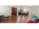 Spacious main bedroom with wood floors featuring a seating area, bookcases and an en suite bathroom at 5040 Mundy Ct, Cumming, GA 30028