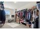 Spacious walk-in closet with custom shelving, a window, and ample storage space at 5040 Mundy Ct, Cumming, GA 30028