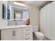 Bathroom with a modern vanity, lighted mirror, and a shower with a curtain at 1280 W Peachtree Nw St # 2601, Atlanta, GA 30309