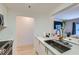 Bright kitchen featuring stainless appliances, stone countertops, and breakfast bar with plants at 1280 W Peachtree Nw St # 2601, Atlanta, GA 30309
