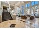 Bright lobby with high ceilings, marble floors, staircase, and large windows overlooking the city at 1280 W Peachtree Nw St # 2601, Atlanta, GA 30309