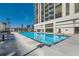Outdoor swimming pool surrounded by a concrete deck and a high-rise building at 1280 W Peachtree Nw St # 2601, Atlanta, GA 30309