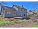 Two-story blue house with a patio overlooking a spacious backyard and trees at 3954 Springleaf Pt, Stone Mountain, GA 30083